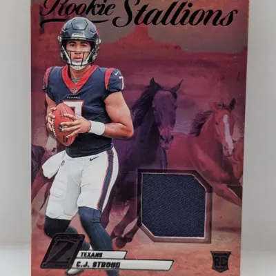 Sale Photo Thumbnail #582: 2023 Zenith Football C.J. Stroud Rookie Stallions jersey relic card featuring a dark blue swatch.