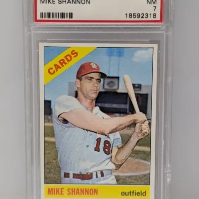Sale Photo Thumbnail #233: 1966 Topps Mike Shannon baseball card #293, graded PSA 7 Near Mint, encased in a protective plastic slab.
