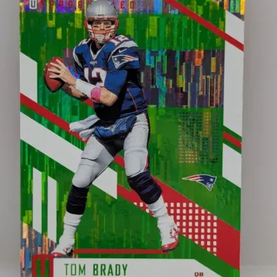 Sale Photo Thumbnail #239: Panini Unparalleled Tom Brady green holographic football card in good condition.