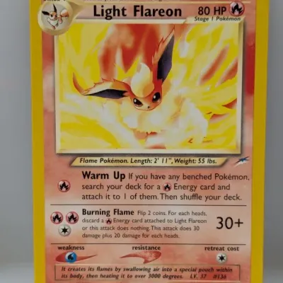 Sale Photo Thumbnail #734: Light Flareon Pokémon trading card from the Neo Destiny expansion set, numbered 46/105, featuring artwork by Atsuko Nishida.