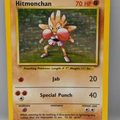 Sale Photo Thumbnail #186: 1999 Pokémon Base Set Holofoil Hitmonchan #7/102 trading card in fair condition showing surface scratching on the foil.