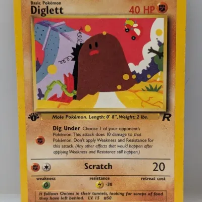 Sale Photo Thumbnail #471: 1st Edition Team Rocket Diglett Pokémon trading card, card number 52/82, illustrated by Sumiyoshi Kizuki and published by Wizards of the Coast in 2000.