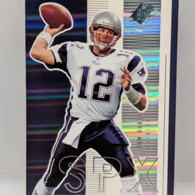 Sale Photo Thumbnail #571: Tom Brady Upper Deck SPx trading card featuring holographic finish and die-cut details, in good raw condition.