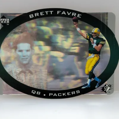 Sale Photo Thumbnail #733: 1996 Upper Deck SPx Brett Favre holographic trading card, featuring a die-cut oval design with portrait and action shots of the Green Bay Packers quarterback.