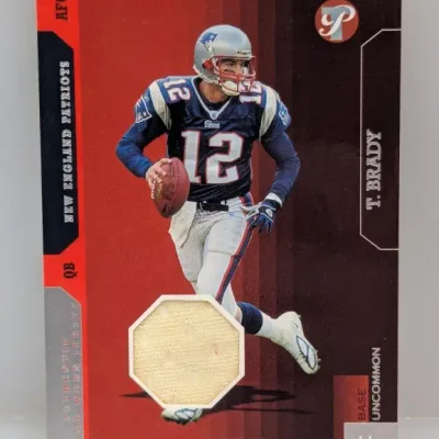 Sale Photo Thumbnail #191: Tom Brady Fleer Tradition authentic game-worn jersey trading card featuring the New England Patriots quarterback in good condition.