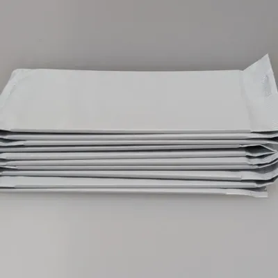 Sale Photo Thumbnail #536: Stack of unopen white foil or plastic sealed envelopes or pouches.