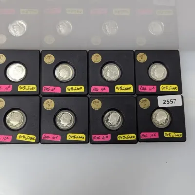 Sale Photo Thumbnail #1048: Collection of 1990s US Roosevelt S-proof 90% silver dimes individually housed in protective black coin cases.