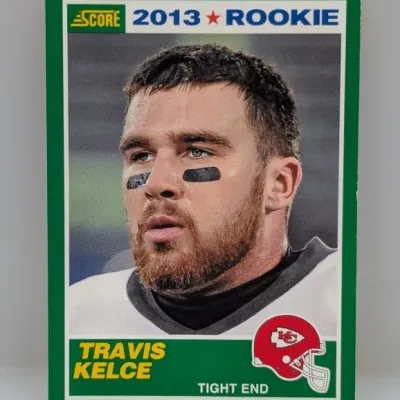 Sale Photo Thumbnail #144: 2013 Score Travis Kelce rookie football trading card (#440) featuring a green border and a Kansas Chiefs helmet graphic.
