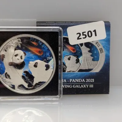 Sale Photo Thumbnail #992: 2021 China 10 Yuan 30g .999 fine silver Panda coin, Glowing Galaxy III edition, in protective case with original box.