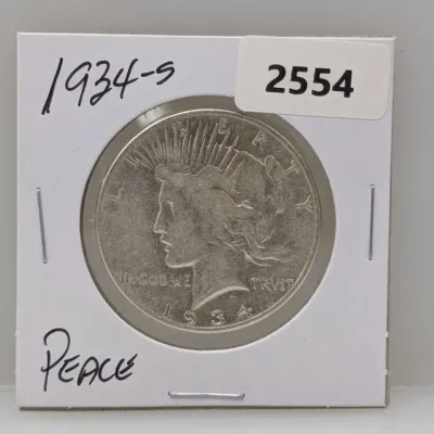Sale Photo Thumbnail #1045: 1934-S Peace silver dollar coin in a cardboard flip holder.