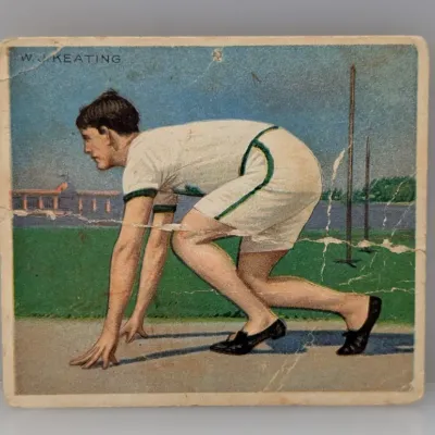 Sale Photo Thumbnail #309: Vintage early-20th-century sports trading card featuring runner W. J. Keating, showing noticeable creasing and surface wear across the card.