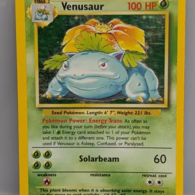 Sale Photo Thumbnail #18: 1999 Pokémon Base Set holo Venusaur #15/102 trading card. The card shows light surface scratches on the foil window and minor edge wear.