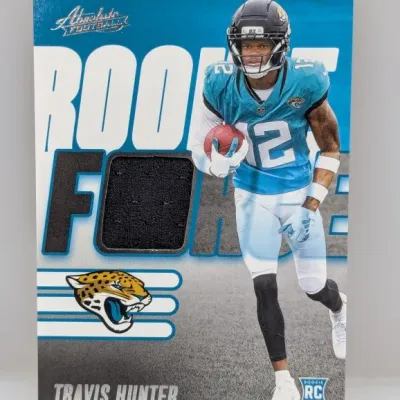Sale Photo Thumbnail #943: Panini Absolute Football Rookie Force relic trading card featuring Travis Hunter of the Jacksonville Jaguars.