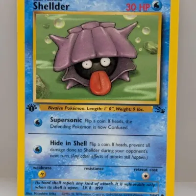 Sale Photo Thumbnail #776: Pokemon Fossil set 1st Edition Shellder trading card #54/62, released in 1999 by Wizards of the Coast.