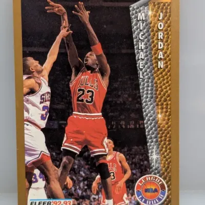 Sale Photo Thumbnail #824: 1992-93 Fleer #238 Michael Jordan League Leader basketball card featuring a gold border.