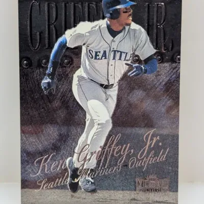 Sale Photo Thumbnail #543: 1999 Metal Universe Ken Griffey, Jr. Seattle Mariners baseball card featuring a metallic industrial-style background.