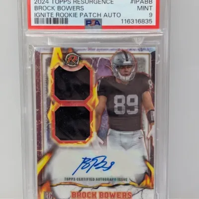 Sale Photo Thumbnail #67: PSA 9 Mint graded 2024 Topps Resurgence Brock Bowers Ignite Rookie Patch Autograph trading card.