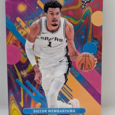 Sale Photo Thumbnail #163: Topps Finest Victor Wembanyama basketball trading card featuring a vibrant, colorful psychedelic background design in crisp condition.