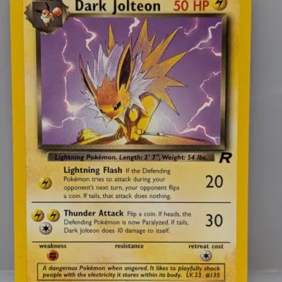 Sale Photo Thumbnail #402: Dark Jolteon Pokémon trading card (38/82) from the 2000 Team Rocket expansion set, illustrated by Mitsuhiro Arita.