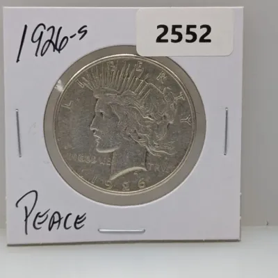 Sale Photo Thumbnail #1043: 1926-S Peace silver dollar coin mounted in a protective cardboard flip holder.