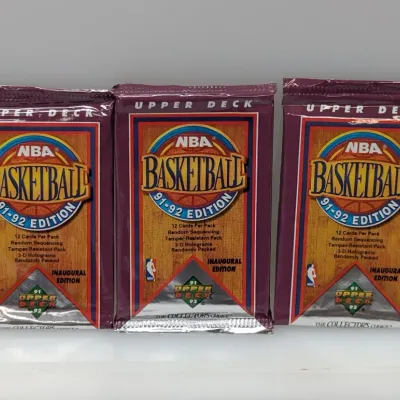 Sale Photo Thumbnail #550: Three unopened packs of 1991-92 Upper Deck NBA Basketball cards, inaugural edition, each containing 12 cards.