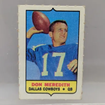 Sale Photo Thumbnail #213: 1969 Topps football stamp card featuring Dallas Cowboys quarterback Don Meredith, showing perforated edges and vibrant colors.