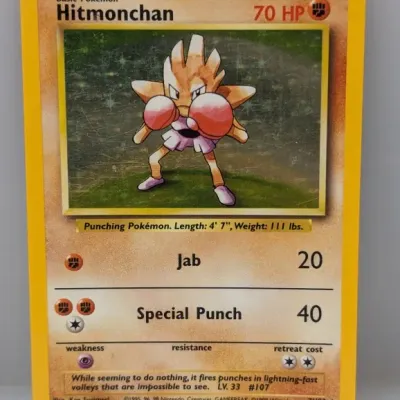 Sale Photo Thumbnail #154: 1999 Pokémon Base Set Holofoil Hitmonchan trading card, numbered 7/102.