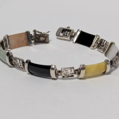 Sale Photo Thumbnail #972: Vintage sterling silver link bracelet featuring multi-color jade and stone panels interspersed with openwork Asian character connectors.