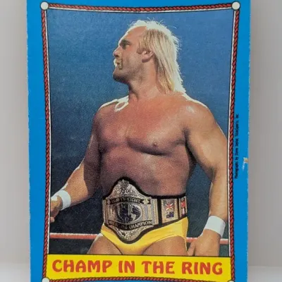 Sale Photo Thumbnail #277: Vintage 1985 Topps WWF Hulk Hogan "Champ in the Ring" trading card with blue borders and minor edge wear.