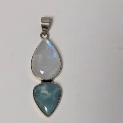 Sale Photo Thumbnail #982: Sterling silver dual-stone pendant featuring teardrop-cut rainbow moonstone and larimar cabochons.