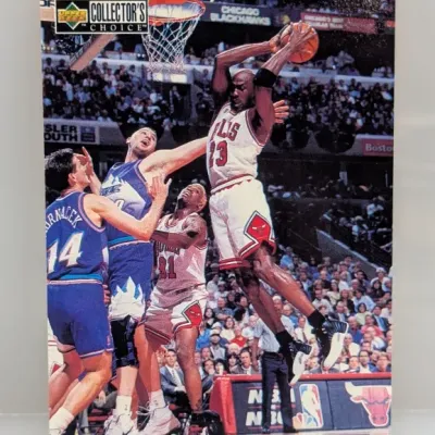 Sale Photo Thumbnail #827: 1997-98 Upper Deck Collector's Choice Michael Jordan basketball trading card #23, featuring an action shot of Jordan dunking against the Utah Jazz.