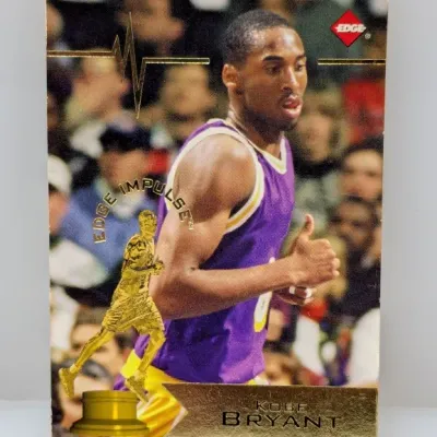 Sale Photo Thumbnail #672: 1996 Edge Impulse Kobe Bryant rookie basketball trading card featuring metallic gold foil accents.