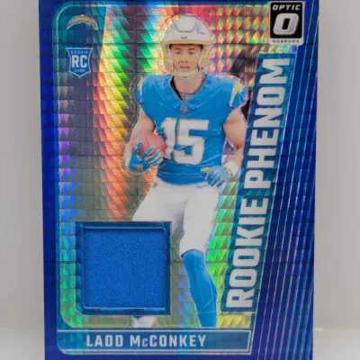 Sale Photo Thumbnail #945: Panini Donruss Optic Rookie Phenom Ladd McConkey trading card with a blue jersey relic swatch.