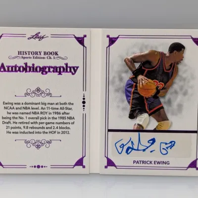 Sale Photo Thumbnail #203: Leaf History Book Sports Edition: Ch. 1 Autobiography Patrick Ewing autographed booklet trading card, featuring purple foil detailing and a career summary.