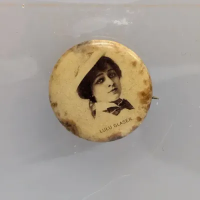 Sale Photo Thumbnail #37: Antique celluloid pinback button featuring stage actress Lulu Glaser, circa early 1900s, showing age-related toning and Foxing along the edges.