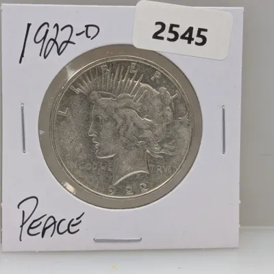 Sale Photo Thumbnail #1036: 1922-D Peace silver dollar coin mounted in a protective cardboard flip holder.