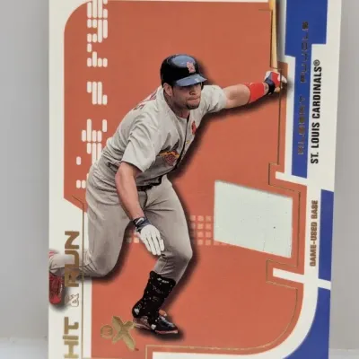 Sale Photo Thumbnail #608: 2003 Fleer EX Hit & Run Albert Pujols trading card featuring an embedded game-used base relic.