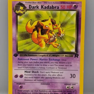 Sale Photo Thumbnail #586: 1st Edition Dark Kadabra 39/82 Pokémon trading card from the Team Rocket expansion, copyright 2000.