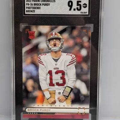 Sale Photo Thumbnail #16: SGC 9.5 MT+ graded 2022 Panini Chronicles Photogenic Bronze Brock Purdy rookie card #PH-36.