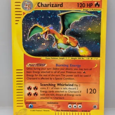 Sale Photo Thumbnail #40: 2002 Pokémon Expedition Charizard holographic trading card, numbered 6/165 and illustrated by Hiromichi Sugiyama.