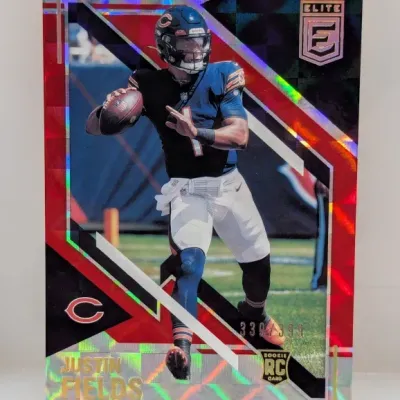 Sale Photo Thumbnail #902: 2021 Donruss Elite Justin Fields rookie card, serial-numbered 339/399 with a holographic red checkerboard finish.