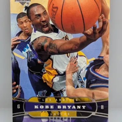 Sale Photo Thumbnail #28: Upper Deck Kobe Bryant Los Angeles Lakers basketball trading card, featuring an action shot of Bryant driving to the basket.