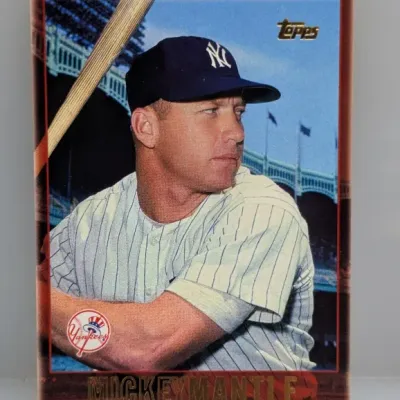 Sale Photo Thumbnail #929: Topps Mickey Mantle baseball trading card featuring a gold foil name and Topps logo overlay.
