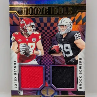 Sale Photo Thumbnail #192: Panini Illusion "Rookie Idols" dual jersey sports card featuring Travis Kelce and Brock Bowers with red and black fabric swatches.