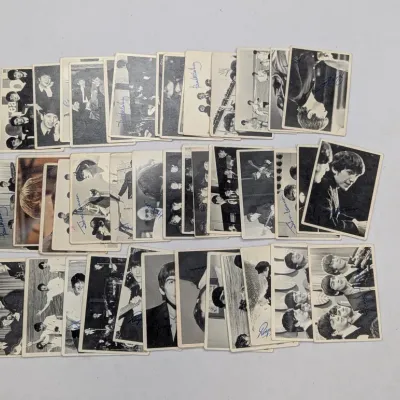 Sale Photo Thumbnail #668: Collection of vintage 1964 A&BC or Topps Beatles black and white trading cards with printed facsimile signatures, arranged in three rows.