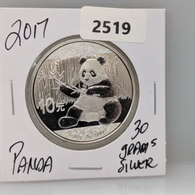 Sale Photo Thumbnail #1010: 2017 Chinese Silver Panda 10 Yuan coin, containing 30 grams of .999 fine silver, housed in a protective cardboard flip holder.