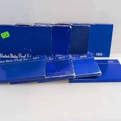 Sale Photo Thumbnail #1058: Collection of US Mint proof sets in original blue packaging, including dates from 1969 through 1983.