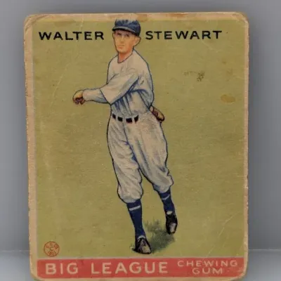 Sale Photo Thumbnail #455: Vintage 1933 Goudey #217 Walter Stewart baseball card featuring 'Big League Chewing Gum' branding. The card shows visible corner wear, creasing, and surface discoloration consistent with age.