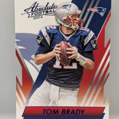 Sale Photo Thumbnail #690: 2014 Panini Absolute Football Tom Brady die-cut trading card featuring him in his New England Patriots uniform.