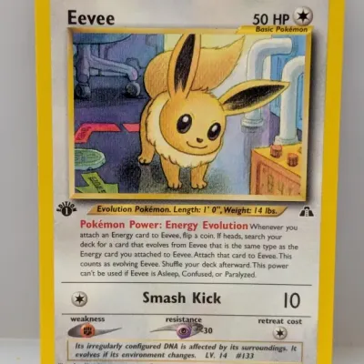 Sale Photo Thumbnail #721: 1st Edition Eevee Pokémon trading card (#38/75) from the 2001 Neo Discovery set, featuring artwork by Aya Kusube.